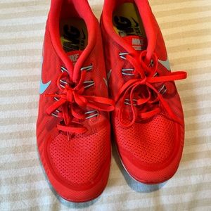 Neon pink/red Nike running shoes
